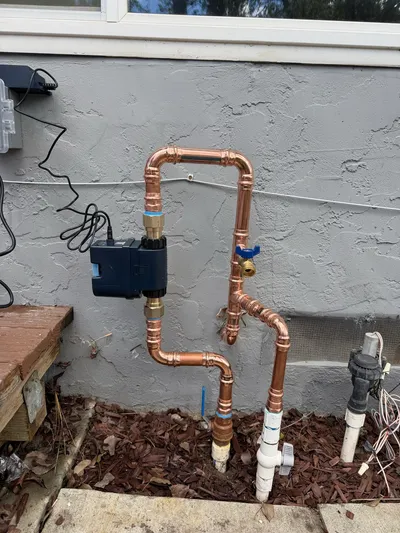 Copper supply pipework rerouted around existing framing during a partial repipe