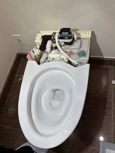 A newly installed toilet set and sealed on a clean flange