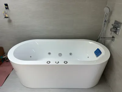 A bath tub installed with its waste and overflow connected and tested