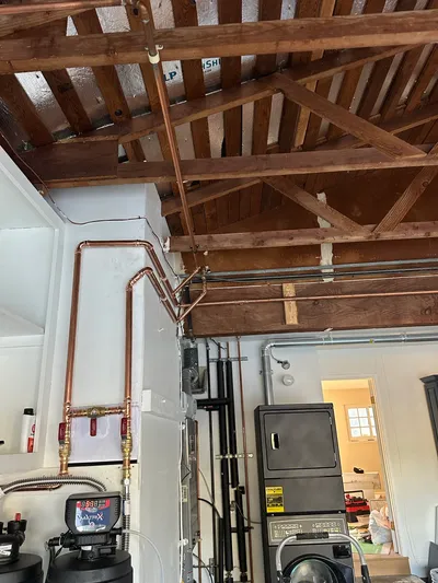 Water treatment supply pipework routed through a crawlspace to reach the incoming main