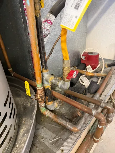A copper manifold with shutoff valves feeding a water treatment system