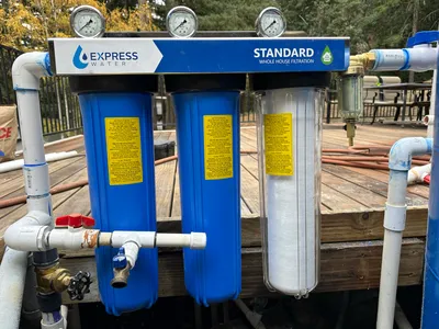 Multi-stage water filter housings fitted with pressure gauges and isolation valves